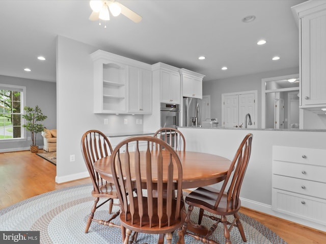 dining area featuring light wood-type flooring, recessed lighting, baseboards, and ceiling fan
