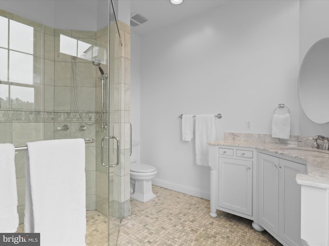 full bathroom featuring a shower stall, vanity, toilet, and baseboards