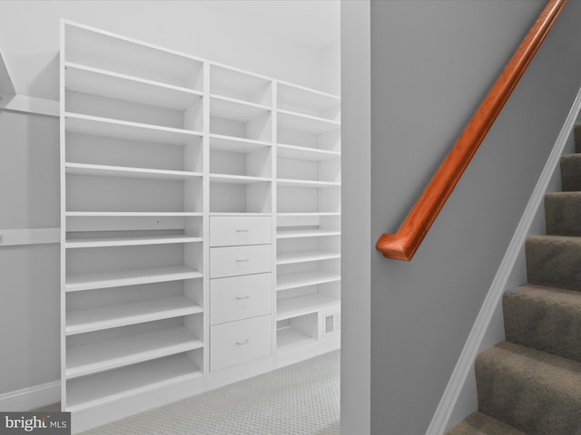 stairs with carpet floors and baseboards