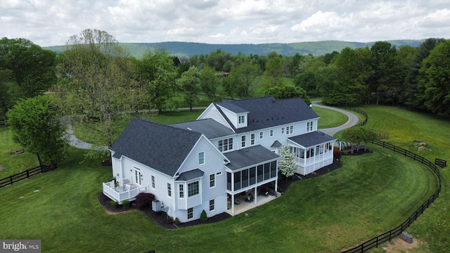aerial view of property and surrounding area featuring a heavily wooded area