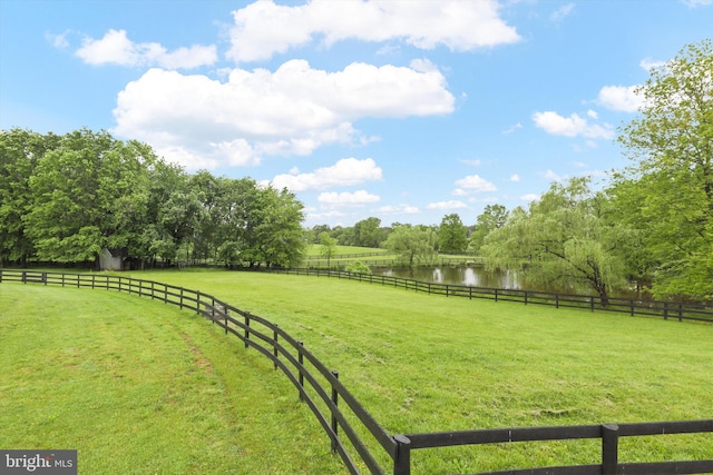 view of yard featuring a rural view and a water view