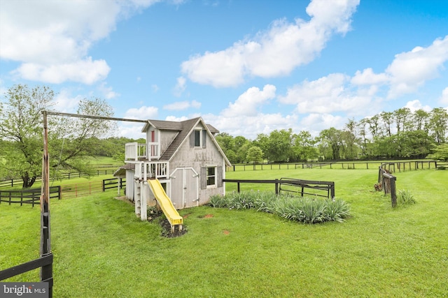 view of property exterior with a view of countryside and view of wooded area