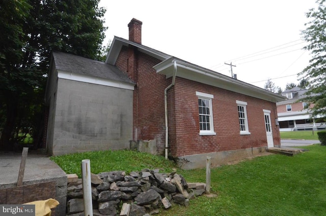 1709 Lampeter Rd, Lancaster, PA 17602 - view of side of property featuring brick siding, a chimney, and a yard
