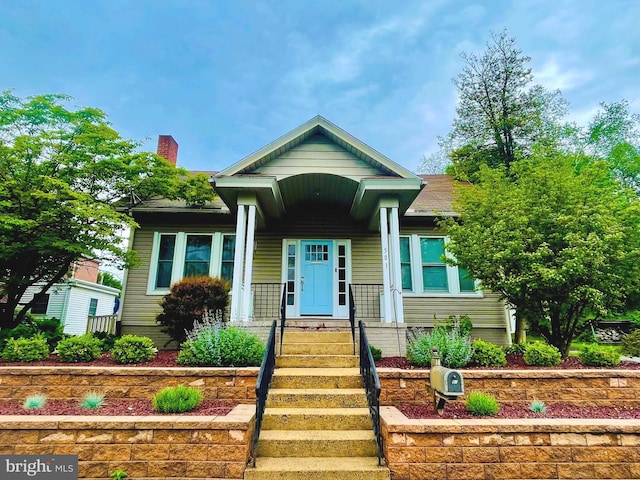 view of front facade featuring a chimney