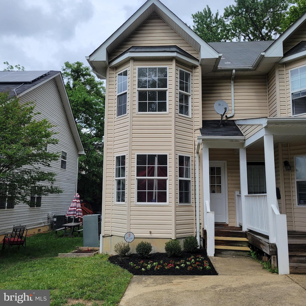 view of front of property with covered porch and central AC unit