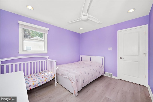 bedroom with wood finished floors, recessed lighting, a ceiling fan, and baseboards