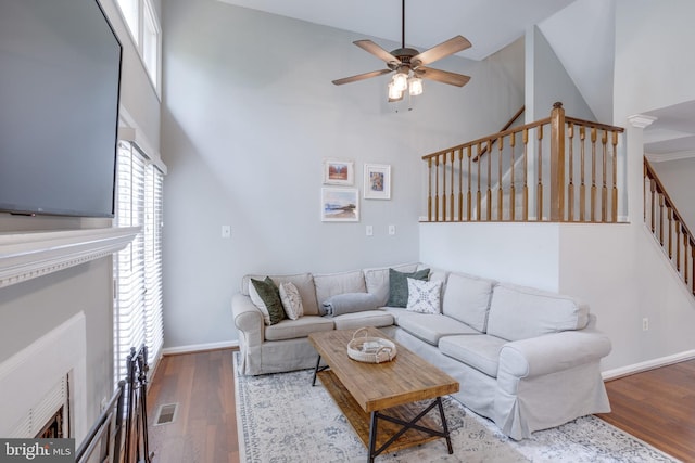 46919 Trumpet Cir, Sterling, VA 20164 - living area featuring a ceiling fan, wood finished floors, a towering ceiling, stairs, and baseboards