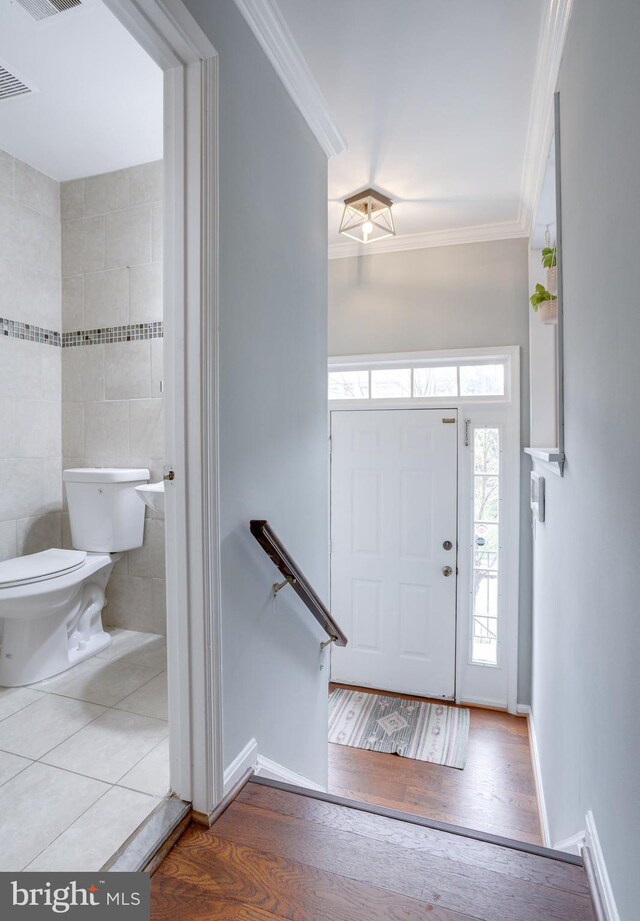 46919 Trumpet Cir, Sterling, VA 20164 - entrance foyer featuring ornamental molding, wood finished floors, and baseboards