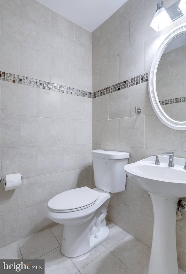 46919 Trumpet Cir, Sterling, VA 20164 - bathroom with tile walls, toilet, tile patterned floors, and a sink