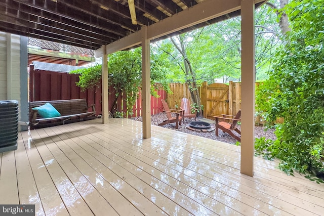 46919 Trumpet Cir, Sterling, VA 20164 - deck with a fenced backyard, a gate, an outdoor fire pit, and cooling unit