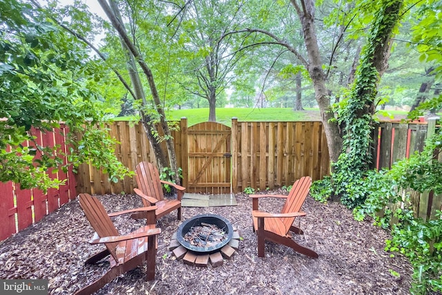 46919 Trumpet Cir, Sterling, VA 20164 - view of patio / terrace with an outdoor fire pit, a gate, and a fenced backyard