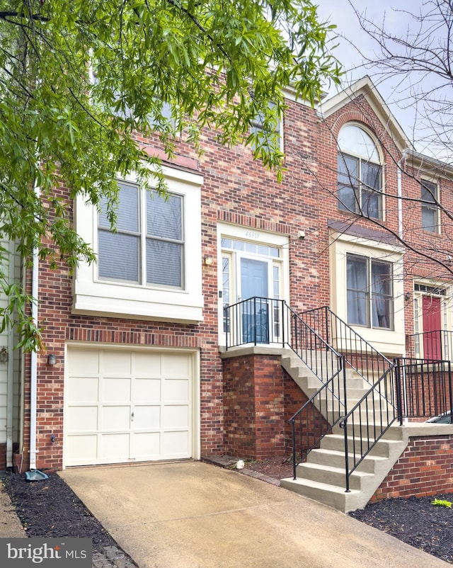 46919 Trumpet Cir, Sterling, VA 20164 - view of property with driveway, brick siding, and a garage