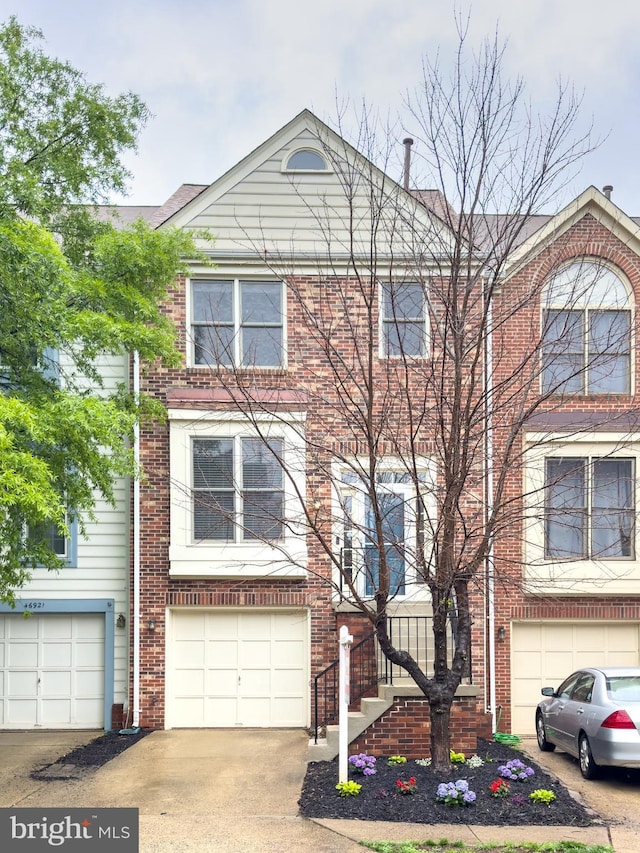46919 Trumpet Cir, Sterling, VA 20164 - view of front of property featuring an attached garage, driveway, and brick siding