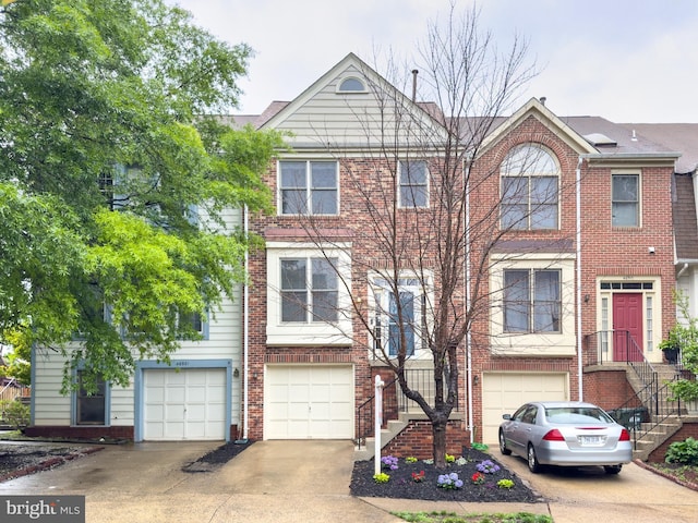 46919 Trumpet Cir, Sterling, VA 20164 - view of property with driveway, a garage, and brick siding