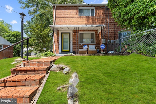 view of front of house featuring brick siding and a porch
