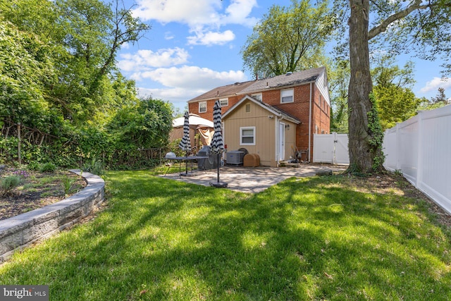 rear view of property featuring a patio area, a gate, central air condition unit, and brick siding