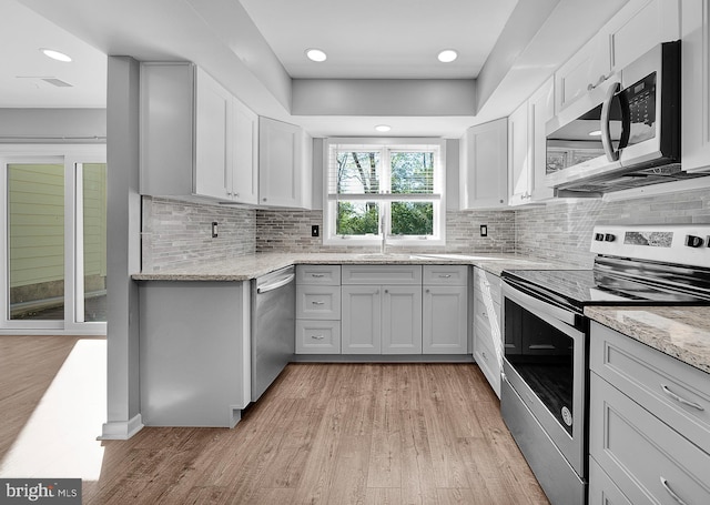 4 Ingham Way, New Hope, PA 18938 - kitchen featuring stainless steel appliances, light wood-type flooring, light stone countertops, backsplash, and recessed lighting