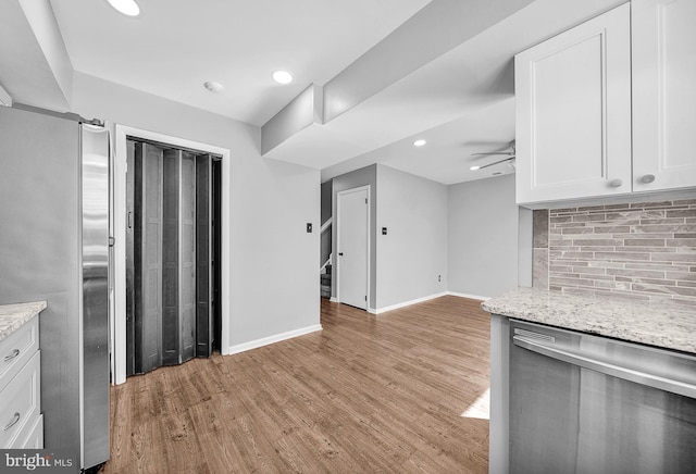 4 Ingham Way, New Hope, PA 18938 - kitchen featuring stainless steel appliances, tasteful backsplash, white cabinets, light wood finished floors, and baseboards