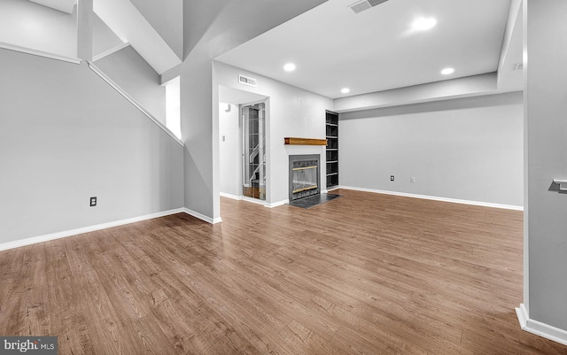4 Ingham Way, New Hope, PA 18938 - unfurnished living room with wood finished floors, a fireplace with flush hearth, baseboards, and recessed lighting