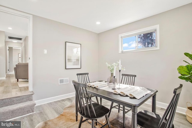 dining room with light wood-style flooring, baseboards, and recessed lighting