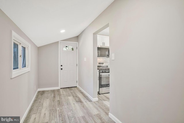 corridor with light wood-style flooring, baseboards, lofted ceiling, and recessed lighting