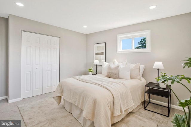 carpeted bedroom with a closet, baseboards, and recessed lighting