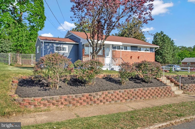 ranch-style home with fence and brick siding
