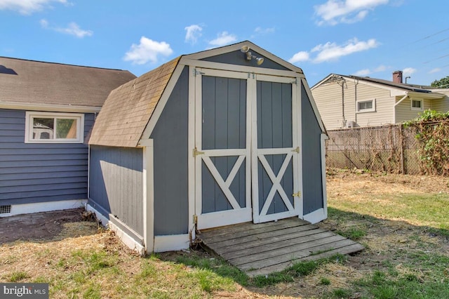 view of shed with fence