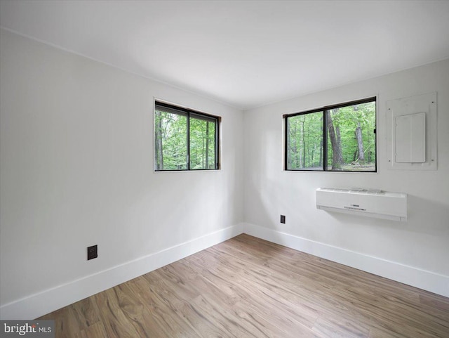 106 Monacan Trl, Hedgesville, WV 25427 - empty room featuring baseboards, a wall mounted air conditioner, and wood finished floors