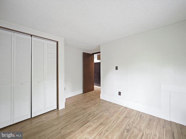106 Monacan Trl, Hedgesville, WV 25427 - unfurnished bedroom featuring wood finished floors, a closet, baseboards, and a textured ceiling
