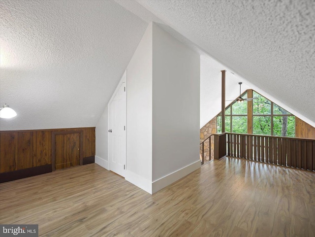106 Monacan Trl, Hedgesville, WV 25427 - additional living space with a textured ceiling, lofted ceiling, wood finished floors, ceiling fan, and baseboards