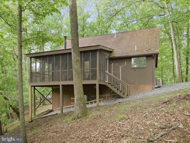 106 Monacan Trl, Hedgesville, WV 25427 - back of property with a sunroom, a chimney, roof with shingles, and stairway