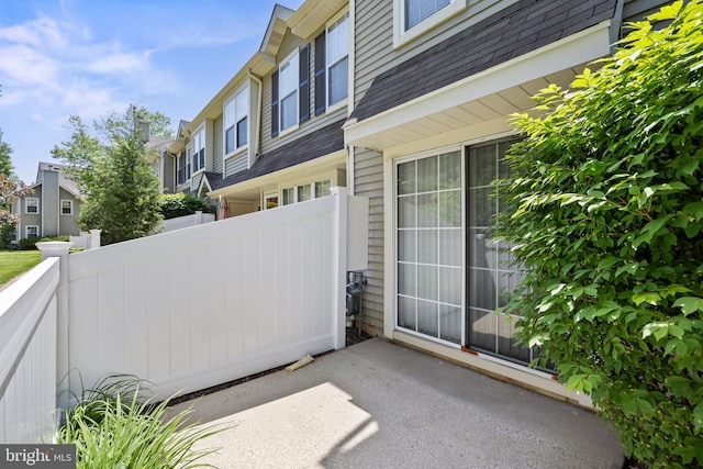 view of patio / terrace with a residential view and fence