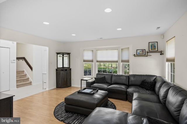 living area featuring stairway, light wood-style flooring, and recessed lighting
