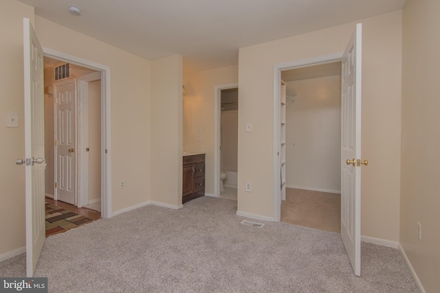 5941 Plumwood Ln, Woodbridge, VA 22193 - unfurnished bedroom featuring light carpet, baseboards, and a spacious closet