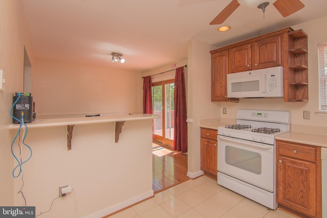 5941 Plumwood Ln, Woodbridge, VA 22193 - kitchen featuring white appliances, brown cabinetry, ceiling fan, and recessed lighting