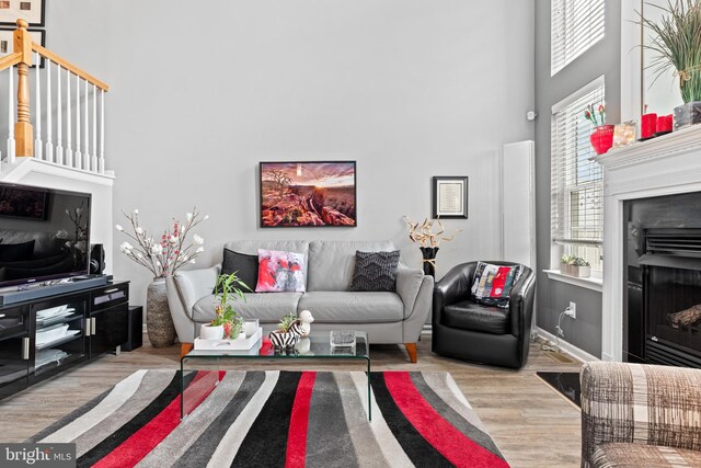 171 Timothy Cir, Wayne, PA 19087 - living room featuring a high ceiling, a fireplace, and wood finished floors