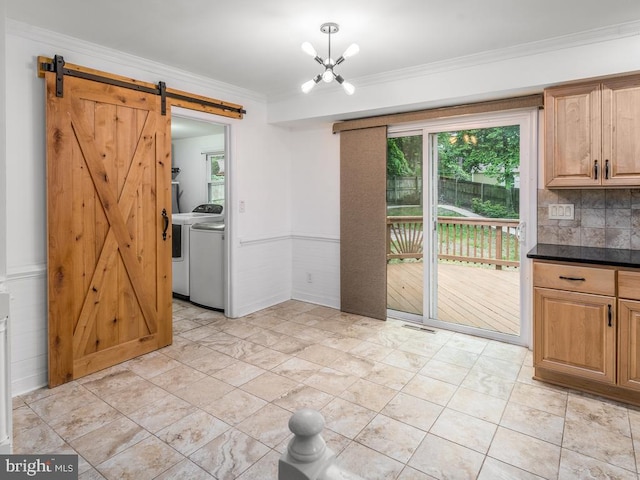 1004 England Dr, Stafford, VA 22554 - unfurnished dining area featuring a barn door, washer and clothes dryer, crown molding, and a chandelier