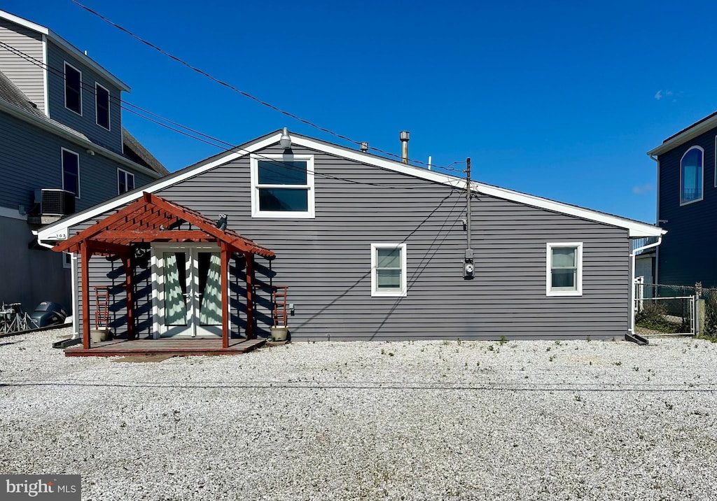 103 N Burgee Dr, Tuckerton, NJ 08087 - view of side of property featuring fence, central AC unit, and a pergola