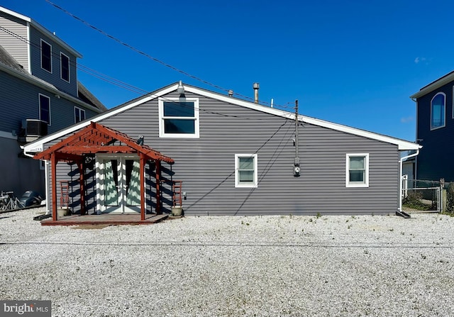 103 N Burgee Dr, Tuckerton, NJ 08087 - view of side of property featuring fence, central AC unit, and a pergola
