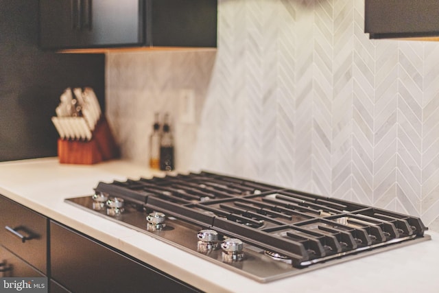 kitchen view of stainless steel gas stovetop and light countertops