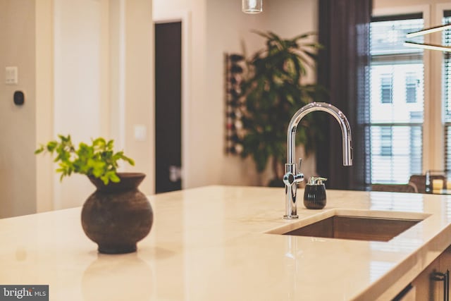 kitchen view of a sink and light countertops