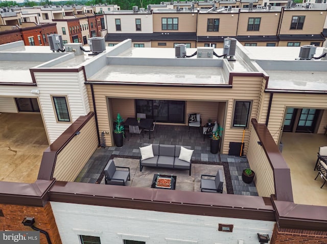 rear view of property featuring central air condition unit and an outdoor hangout area