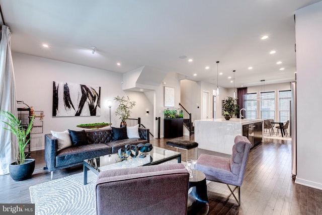 living room featuring stairs, dark wood-style flooring, recessed lighting, and baseboards