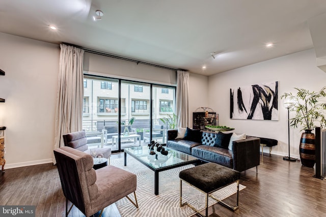 living room with dark wood finished floors, baseboards, and recessed lighting