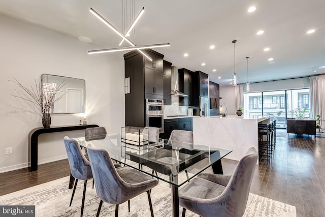 dining room with recessed lighting, wood finished floors, and baseboards