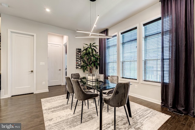 dining space with dark wood-style flooring, baseboards, and recessed lighting