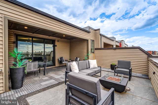 view of patio / terrace with an outdoor living space with a fire pit and a wooden deck