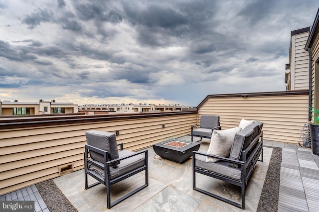 view of patio featuring an outdoor living space with a fire pit