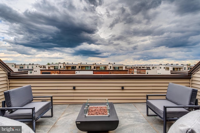 view of patio / terrace with a fire pit and a residential view